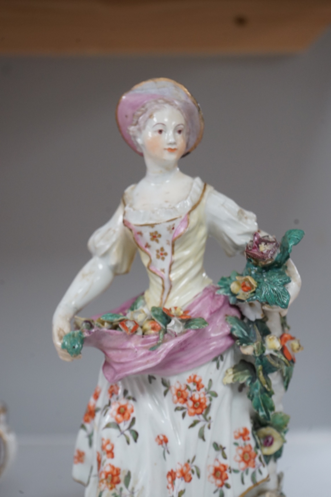A Derby figure of a flower seller, c.1760, restored, 24cm high